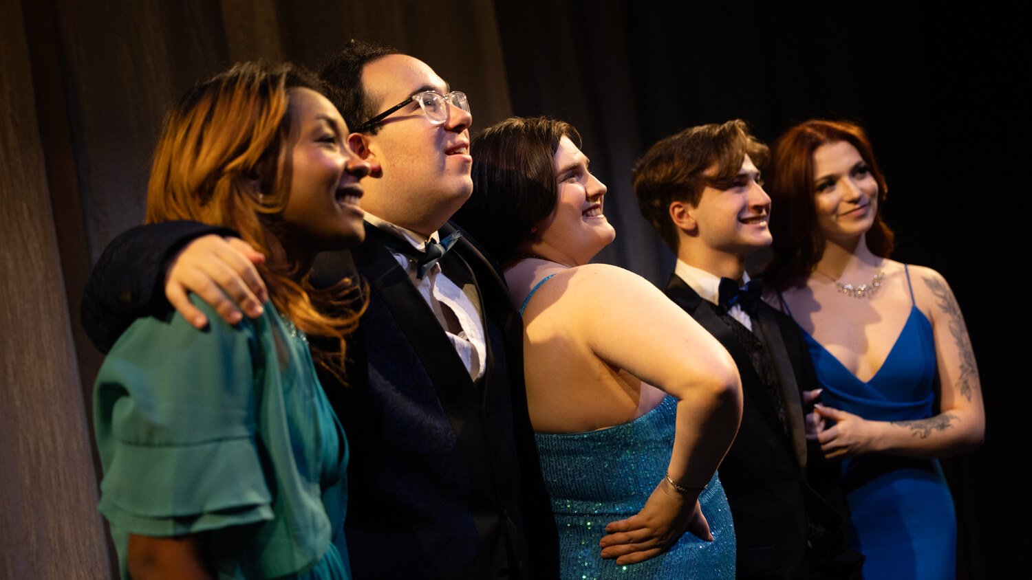 Quinnipiac Theater students pose for a photo on stage.