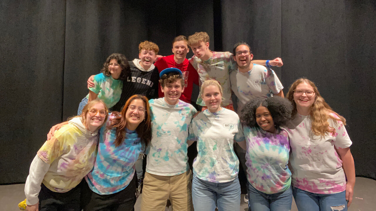 11 students smiling for the camera