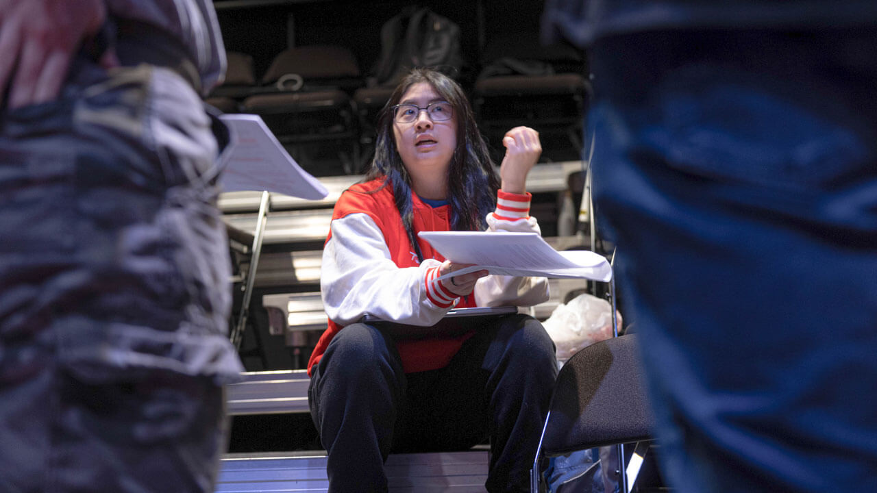 A student participates in a production in the new play lab